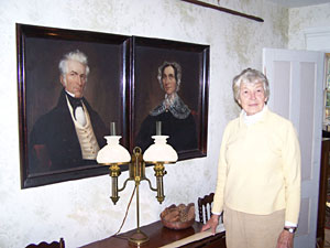 Mystery author Cynthia Riggs stands in the front hall of her ancestral home.